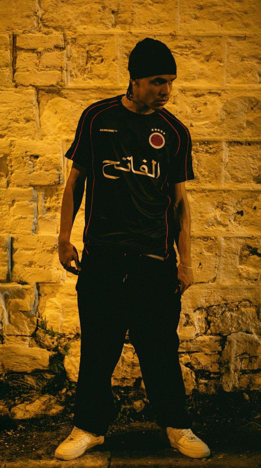 THE CONQUEROR FOOTBALL TEE (BLACK) (RED AND WHITE DETAILS)